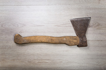 Old and dirty axe on wood background