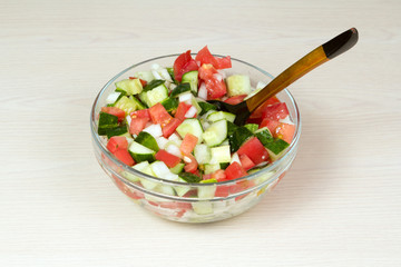 Vegetable salad with onion, tomato and cucumber