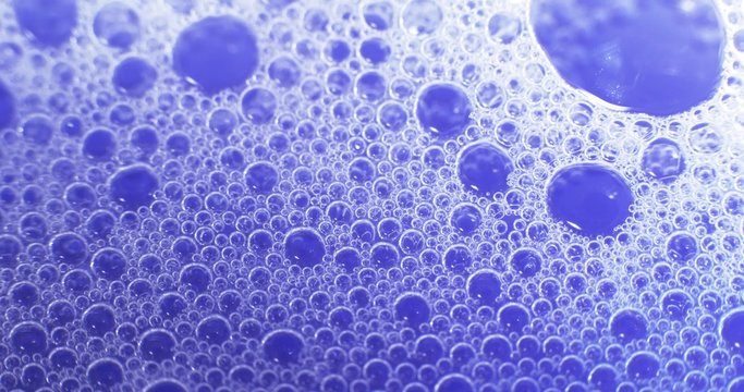 Blue soap bubbles in water. Extreme macro footage. Shot on RED 4k