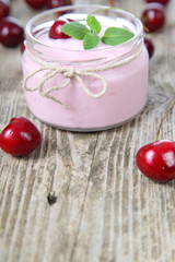 Obraz na płótnie Canvas Cherry yogurt and ripe cherry