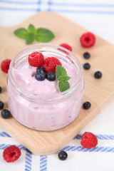 Yogurt and ripe blueberries and raspberries