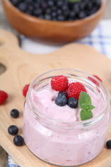 Yogurt and ripe blueberries and raspberries