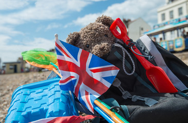 Teddy bear escapes to Weymouth beach, Dorset, England for a traditional bucket and spade summer...