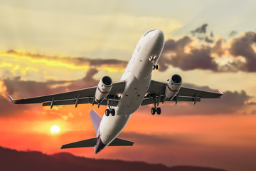 Fototapeta na wymiar Passenger business airplane take off and flying on sky sunset, u