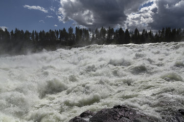 A wild river on a cloudy sky