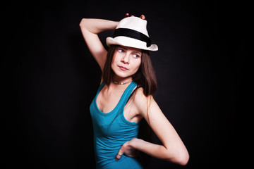 Naklejka premium young woman in white hat on black background