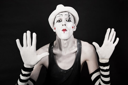 mime in striped gloves and white hat