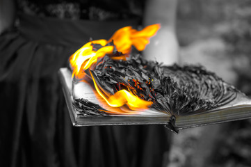 Abstract background - the burning book in women's hands