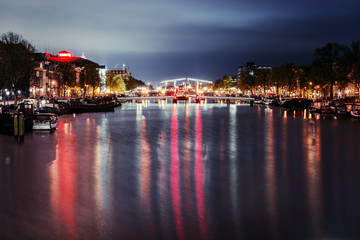 Fototapeta premium Beautiful night in Amsterdam. Night illumination of buildings an