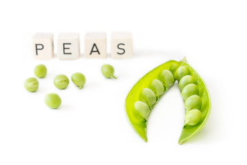 Green peas isolated on white background with letters