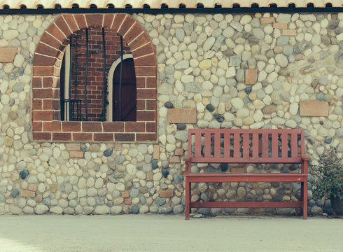 red bench with wall - soft focus in vintage film filter