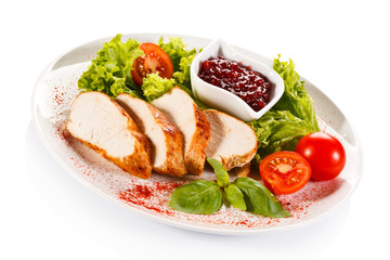 Roast chicken fillet and vegetables on white background 