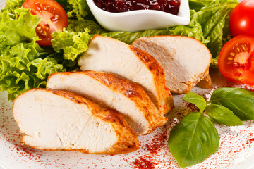 Roast chicken fillet and vegetables on white background 