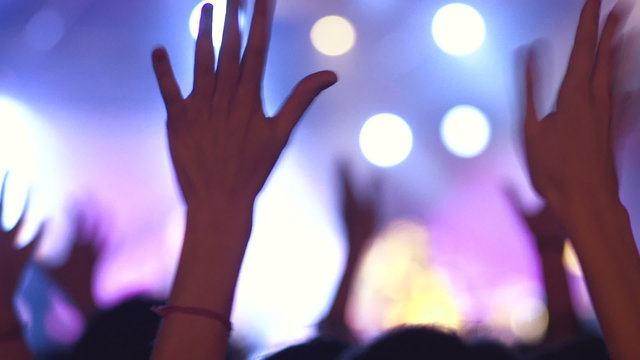 At a Concert. Concert crowd climax, clapping hands. Live performance, nightlife event.