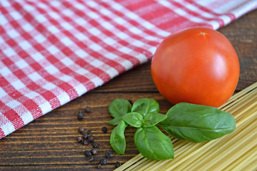  Spaghetti, fresh tomato and basil on wooden background