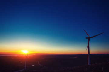Solar wind turbines at sunset.
