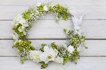 Flower wreath with orchids, carnations, hypericum and gypsophila