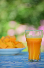 Glass of a tasty pumpkin juice and pumpkin,