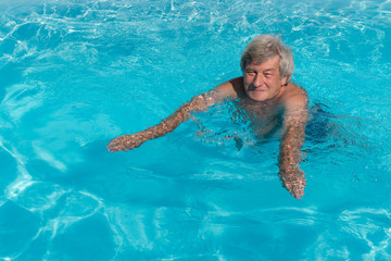 Active senior man swimming