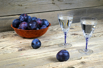 Two glasses of plum brandy with plums