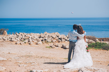 Bride and groom by the sea on their wedding day
