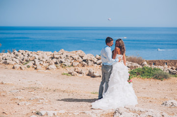 Bride and groom by the sea on their wedding day