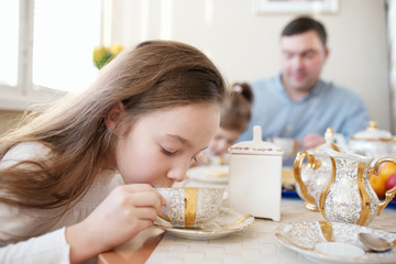 cute little girl drinks tea