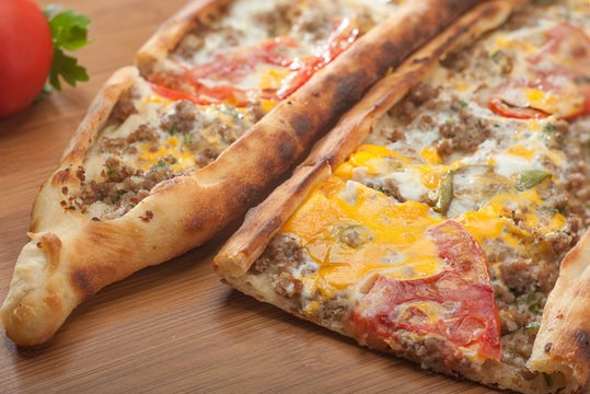 Turkish pide with cheese, tomatoes and peppers