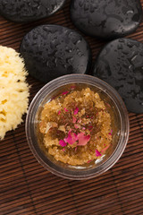 Homemade body peeling with sugar, olive oil and rose petal
