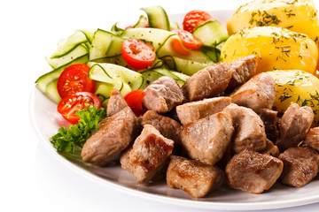 Grilled meat with boiled potatoes and vegetables 