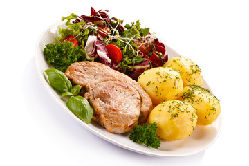 Fried steak, boiled potatoes and vegetable salad 