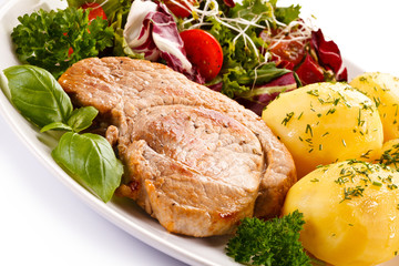 Fried steak, boiled potatoes and vegetable salad 