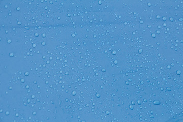 Rain Water droplets on blue waterproof fabric