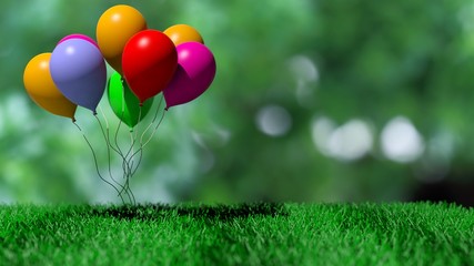 Group of colorful balloons on green grass and abstract background