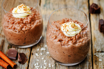 chocolate rice pudding decorated with whipped cream with cinnamo