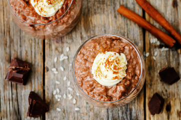 chocolate rice pudding decorated with whipped cream with cinnamo