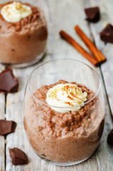 chocolate rice pudding decorated with whipped cream with cinnamo