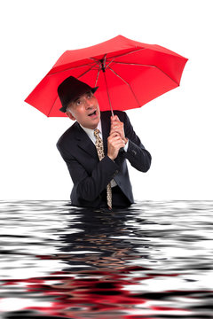 Business man with umbrella getting flooded