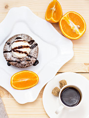 Warm dessert chocolate cake Fondant served on plate with ice-cream ball, almond chips, mint, icing, citron, cacao