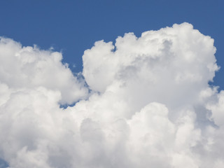 Naklejka na ściany i meble White cumulus clouds in the blue sky
