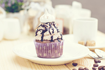 Chocolate Cupcake with chocolate frosting on the table