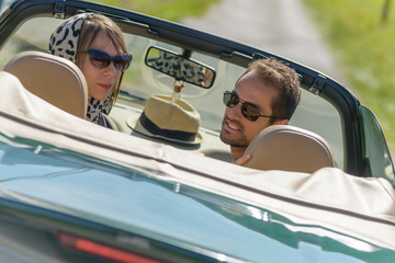 a young couple in a convertible car