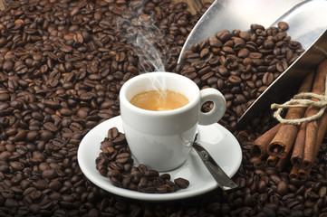 Cup of coffee on the table with seeds