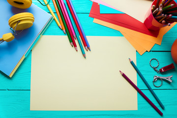 School accessories with copy space on wooden table. Top view