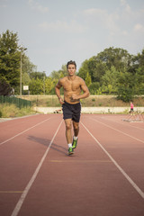 Obraz premium Runner on a track. Frontal full body shot.