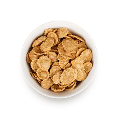 Multigrain flakes in small white plate, isolated. 