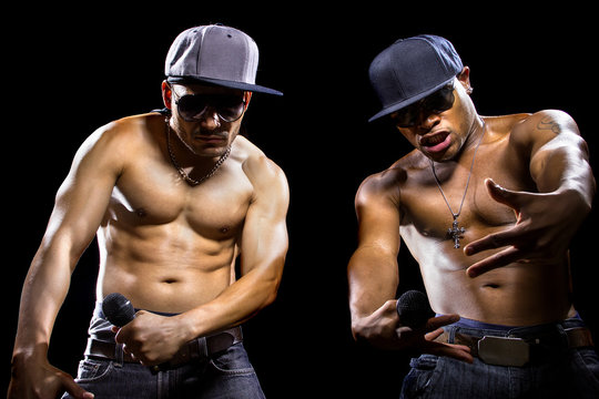 Rap concert with two muscular shirtless men with microphones