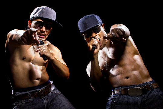 Rap concert with two muscular shirtless men with microphones