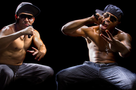 Rap concert with two muscular shirtless men with microphones