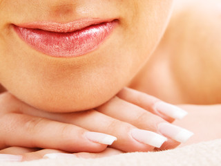 Fototapeta premium Young woman's lips and hand
